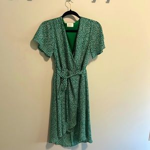 Green polka dot dress in a faux wrap style